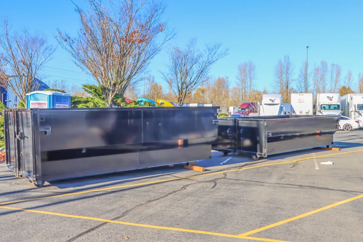 Professional dumpster rental service with roll-off container on residential driveway in Iona